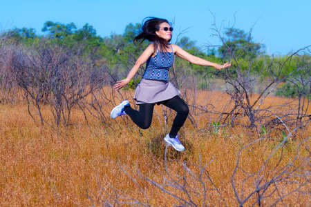 Lady erlax enjoy outdoor in field dry grass at Mukdahan Nation Park, Thailand