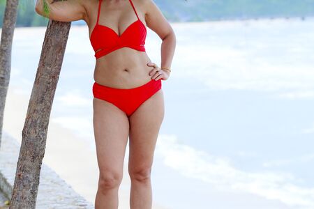 Woman body and breast sex symbol with red bikini on beach at Klong Wan beach, Prachuap Khirikhan Province Thailandの写真素材