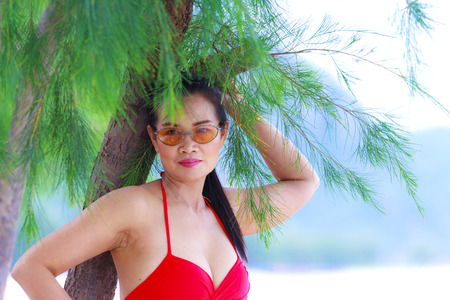 Women pretty breast with red bikini on beach at Klong Wan beach, Prachuap Khirikhan Province...