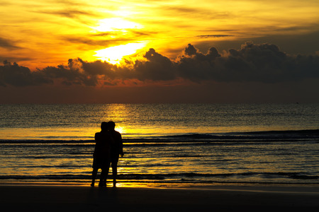 The tourist hapy silhouette and sunrise on beach at Ban Krut Beach, Prachuap Khirikhan Province Thailandの写真素材