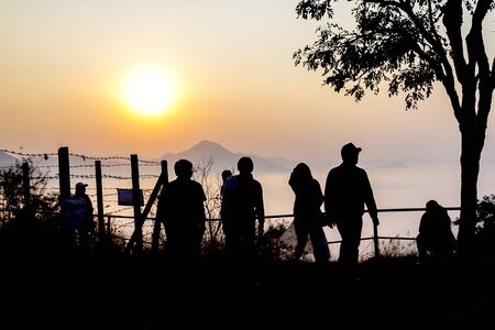 Silhouette group tourists morning and sunrise at viewpoint countryside in Thailand