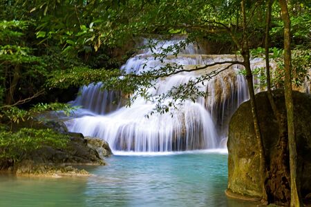 Waterfall the Erawan Waterfall idyllic in green forest and is rain forest of Kanchanaburi province, Thailandの写真素材