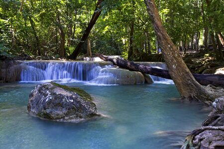 Waterfall the Erawan Waterfall is famous in green forest and is rain forest of Kanchanaburi province, Thailandの写真素材