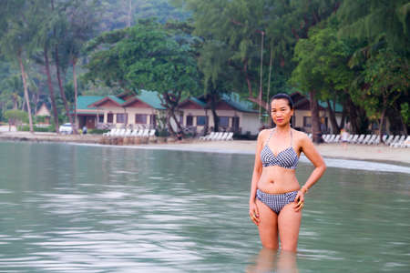 Woman in bikini is walking morning at beach Koh Chang Thailand.
Koh Chang is located in the eastern Gulf of Thailand. It is an island with beautiful nature. Famous for tourismの写真素材