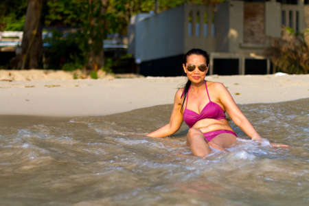 Woman in bikini pretty sit happy with wave on beach at beach Koh Chang Thailand.
Koh Chang is located in the eastern Gulf of Thailand. It is an island with beautiful nature. Famous for tourismの写真素材