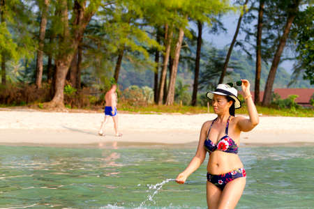 Woman with hat and bikini at beach Koh Chang Thailand.
Koh Chang is located in the eastern Gulf of Thailand. It is an island with beautiful nature. Famous for tourismの写真素材