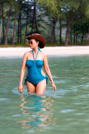 Woman in blue swimsuit walk play on water at beach Koh Chang Thailand.
Koh Chang is located in the eastern Gulf of Thailand. It is an island with beautiful nature. Famous for tourismの写真素材
