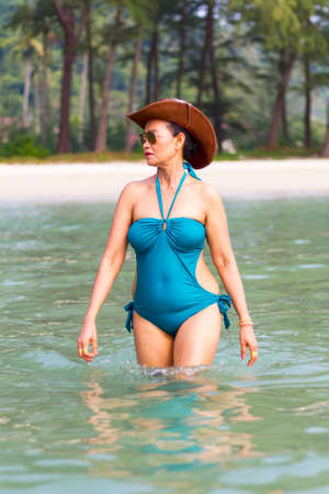 Woman in blue swimsuit happy walk on water at beach Koh Chang Thailand.
Koh Chang is located in the eastern Gulf of Thailand. It is an island with beautiful nature. Famous for tourismの写真素材