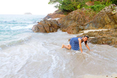 Woman happy with wave in morning on Lonely Beach at beach Koh Chang Thailand.
Koh Chang is located in the eastern Gulf of Thailand. It is an island with beautiful nature. Famous for tourismの写真素材
