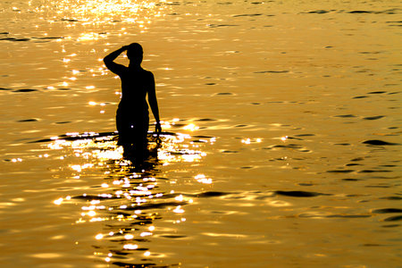 Sunset and woman with silhouette on beach at Koh Chang Thailand.の写真素材