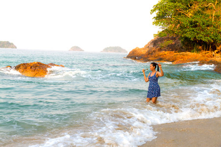Woman enjoy with wave morning on Lonely Beach at beach Koh Chang Thailand.の写真素材