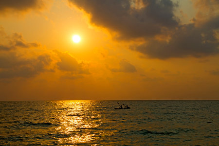 Sunset and small boat on Lonely beach at Koh Chang Thailand.の写真素材