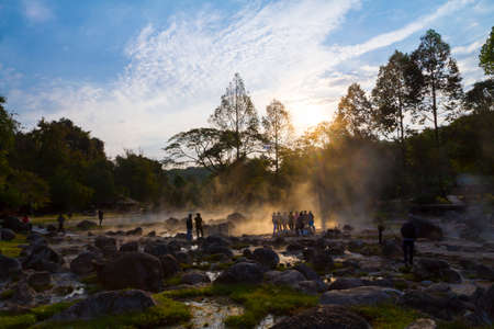 Hot springs and traveler on sunlight of sunrise in the morning at Chae Son National Park , Lampang province Thailand.の写真素材