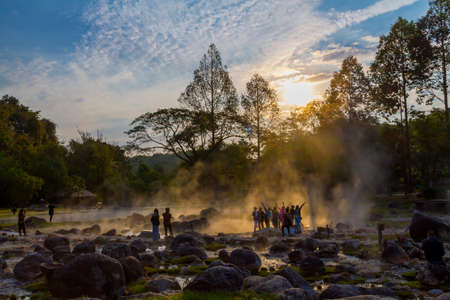 Hot springs and traveler on sunlight of sunrise in the morning at Chae Son National Park , Lampang province Thailand.の写真素材