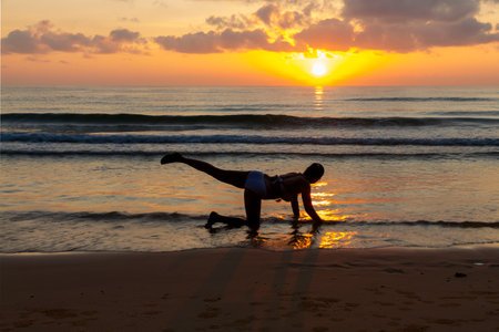 Woman in bikini exercises at sunrise morning at beach Bang Boet , Prachuap Khiri Khan Province in Thailand is famous for travel and relax.の写真素材