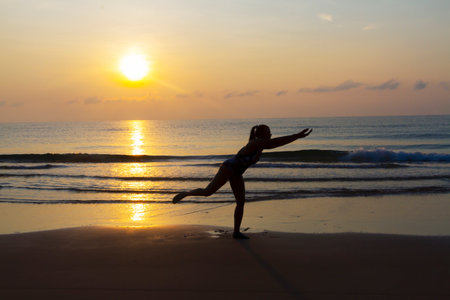 Sunrise and silhouette traveler on beach at beach Bang Boet, Prachuap Khiri Khan Province in...