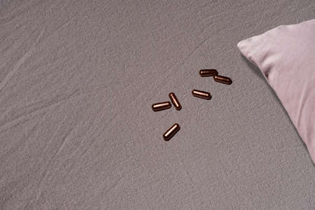 Sleeping drug capsule on in the bed , depression idea , dangerouse decision , mistake.の写真素材