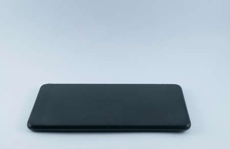Side view black screen smartphone on isolated background.