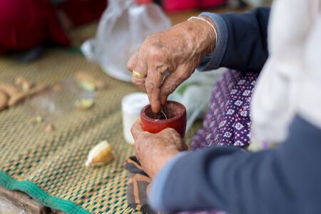 Grandma used a spoon for scoop to eat betel.の写真素材