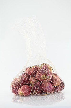 Shallot onions in Mesh Bagの写真素材