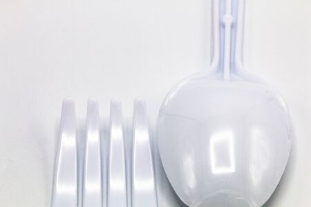 Cost-up plastic spoon and fork isolated on white background. It copy space and selection focus.の写真素材