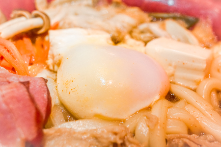 Japanese food. Udon noodles with bacon, sliced ââpork, egg bael,carrots and mushroom.Closed up.Copy space.(Soft focus)の写真素材