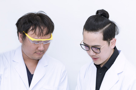 Young handsome scientist student talking research assistant.Professor in whit suit and glasses.Copy space.の写真素材