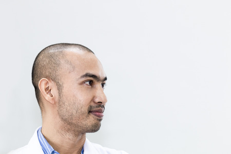 Senior handsome researcher thinking about dream.Doctor in white suit .Copy space.の写真素材