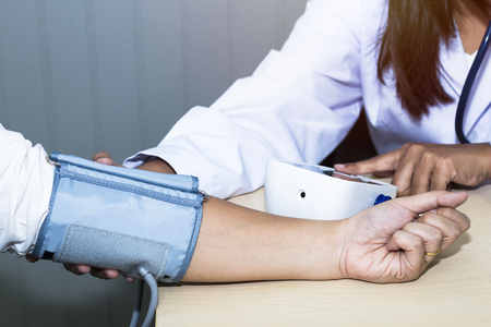 Hand woman professional doctor check blood pressure with patient at hospital.Copy space.の写真素材
