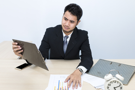 Young businessman  is 20-30 years old strain and worry at office.Manager in black suite thinking about problem project work.Copy space.の写真素材