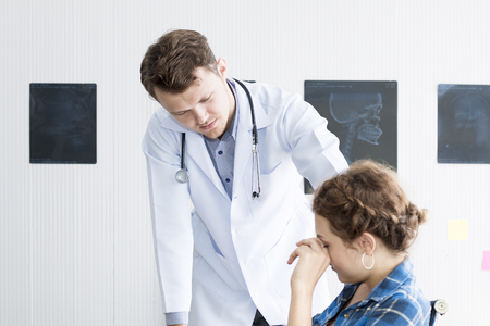 Medical professionals caucasian man reassuring and talking with young woman stress patient.Close up and copy space.の写真素材