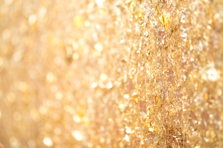 Texture of the gold leaf  on the wall background select focus and bokeh.の写真素材