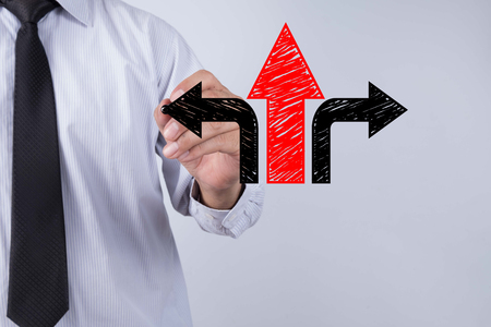 Businessman draw arrows. Decision or strategy conceptの写真素材