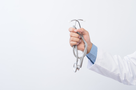 Doctor holding a stethoscope and word on white background,  Healthcare concept.の写真素材