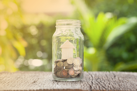 Money and house in gless, Saving money concept, concept of financial savings to buy a house,trees growing in a sequence of germination on piles of coins, Growth, business, money.の写真素材