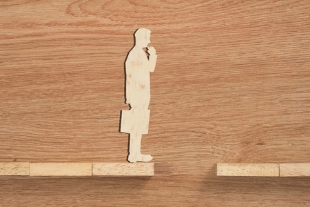 Concept of problem and difficulty of a businessman. Wooden blocks and businessmanの写真素材