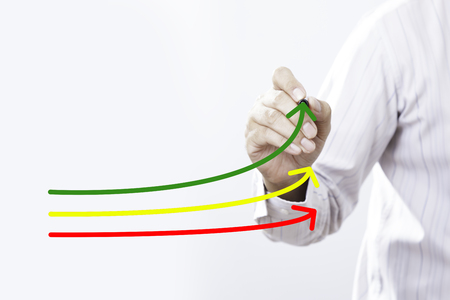 Benchmarking and market leader concept. Manager (businessman, coach, leadership) draw graph with three lines, one of them represent the best company in competition.の写真素材