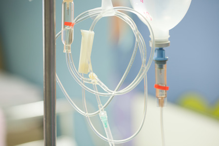 Close up saline IV drip for patient and Infusion pump in hospital.の写真素材