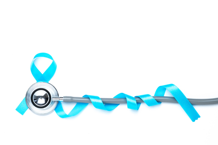 light blue awareness ribbon and a stethoscope for prostate cancer awareness campaign and men's health concept in November and September month.の写真素材