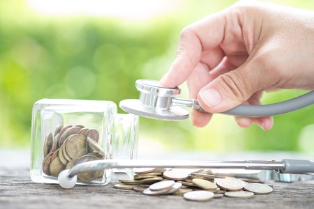 Stethoscope on bottle and coin on wooden background ,Determined image for solution or key to protect...