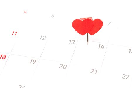 Valentines day concept. Paper red hearts pin on day 14th february at calendarの写真素材