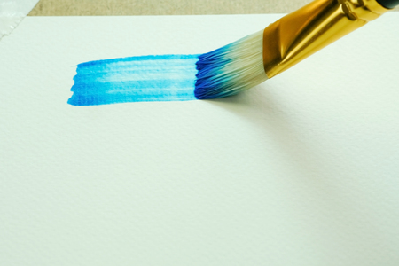 Closeup a blue rectangle in watercolors using a paintbrush on watercolors paper 200 GSM.の写真素材