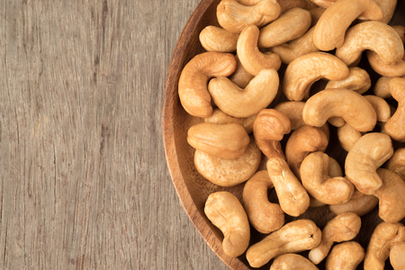 Cashew nuts in wooden bowl  on woden table.の写真素材