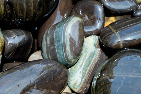 Beautiful wet black stones at Koh Hin Ngam in summer time concept travel, holiday and vacation....