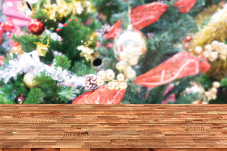 Perspective empty wooden table and christmas tree blur decoration background, for product display montage or design layout.の写真素材
