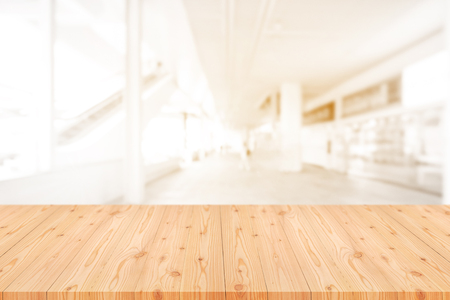 Empty wooden table top with blurred of coffee shop, cafe, bar background, Abstract background can be used for display or montage your products.の写真素材
