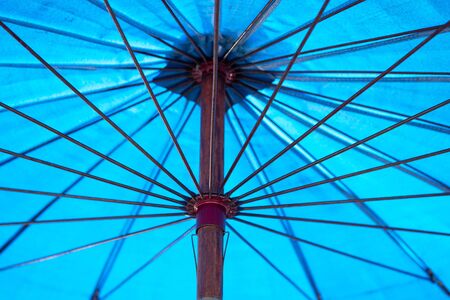 Close up view of the inside of an open, blue umbrella. の写真素材