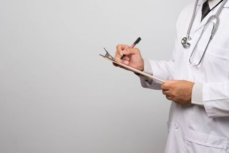 Doctor holding clipboard with sheet of paper. Doctor and stethoscope. Health care concept.