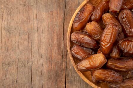 Close up of cluster dates plam. Fresh dates plam on wooden table.