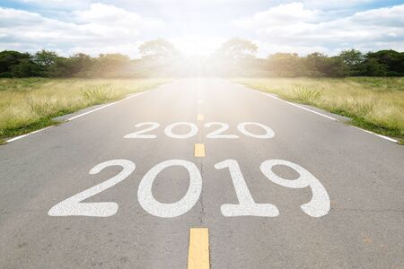 2020, 2019 word writen on asphalt road with natural background. Business concept.の写真素材